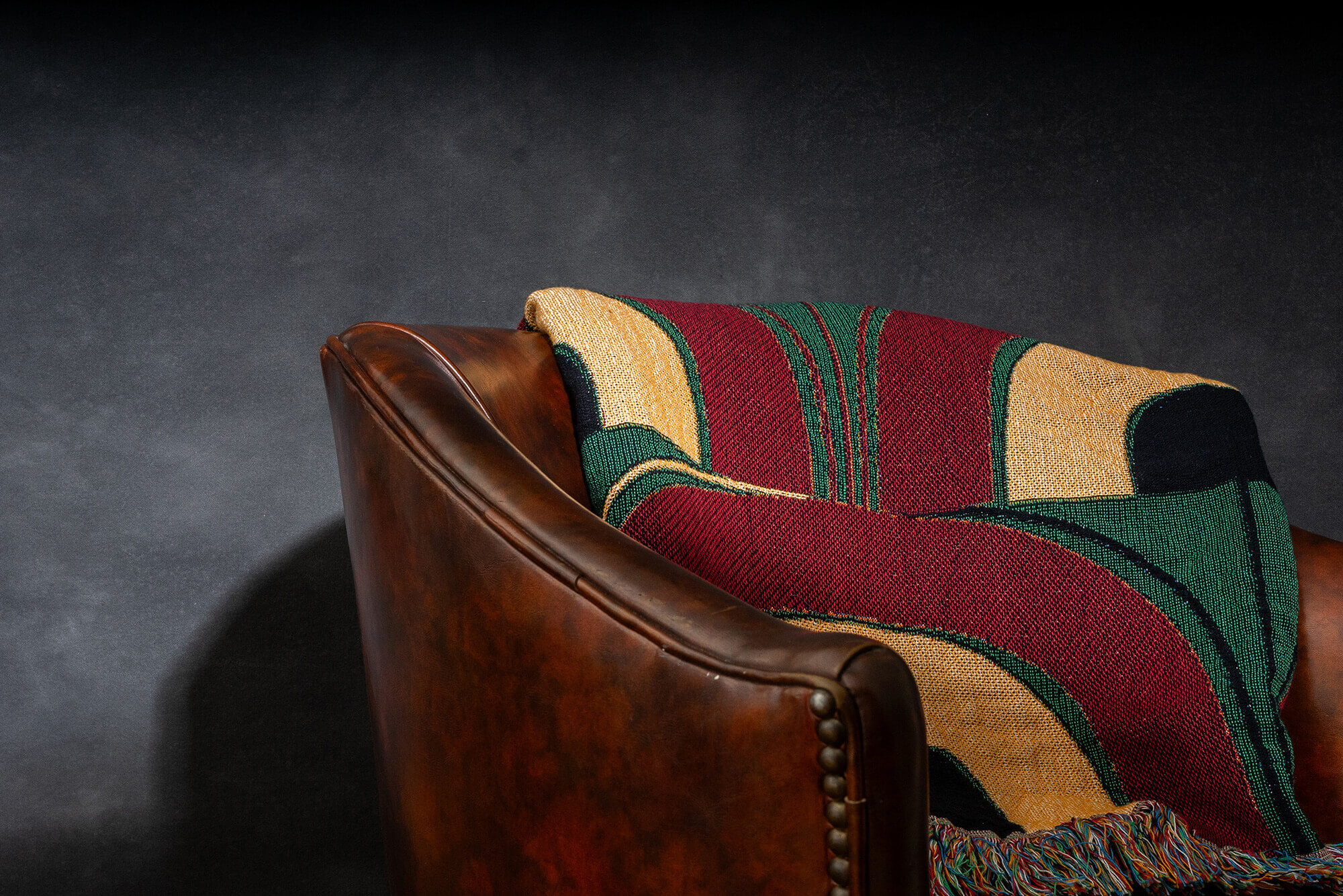 arches blanket on leather chair against cold smokey background