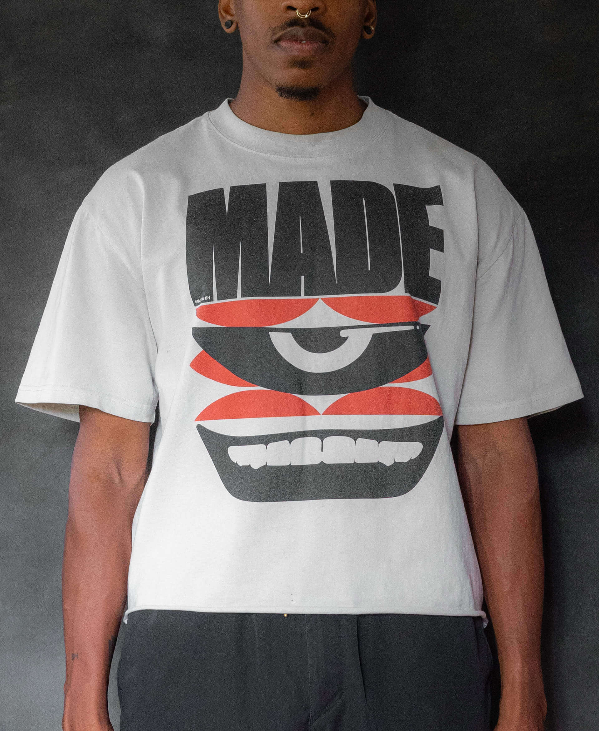 a photo of Made Prideful T-shirt against a smokey black/grey background