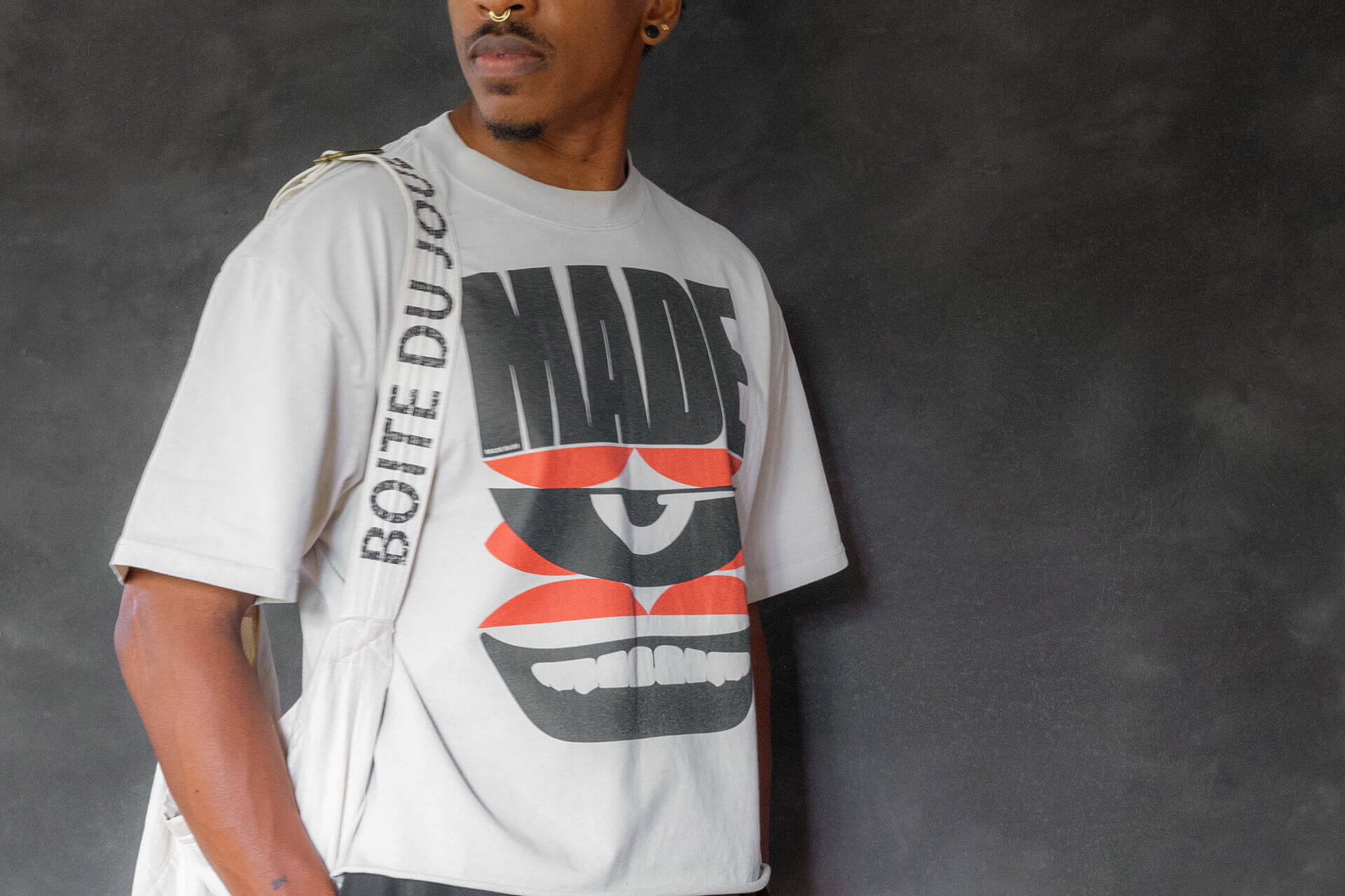 made pride ful tee with a bag strap going down the shoulder